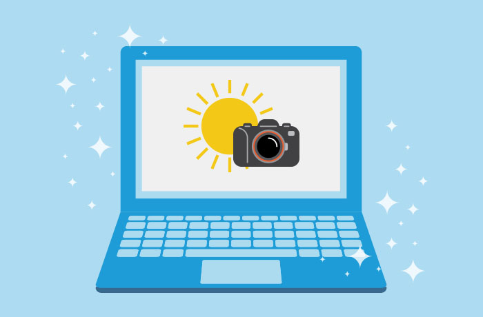 蓝笔记本电脑前面蓝背景图画 屏幕上黄太阳前黑相机